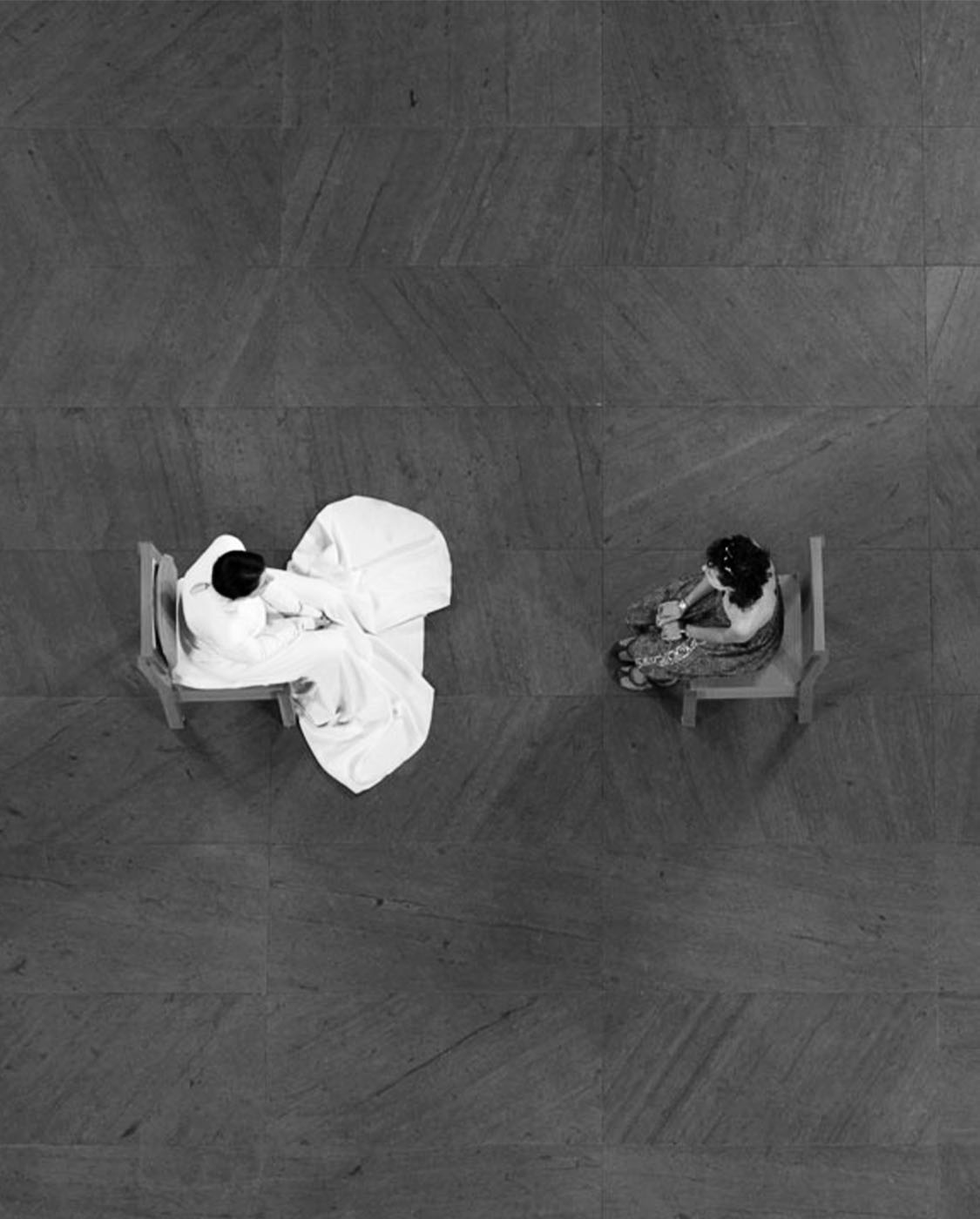 Two women sitting in chairs facing each other