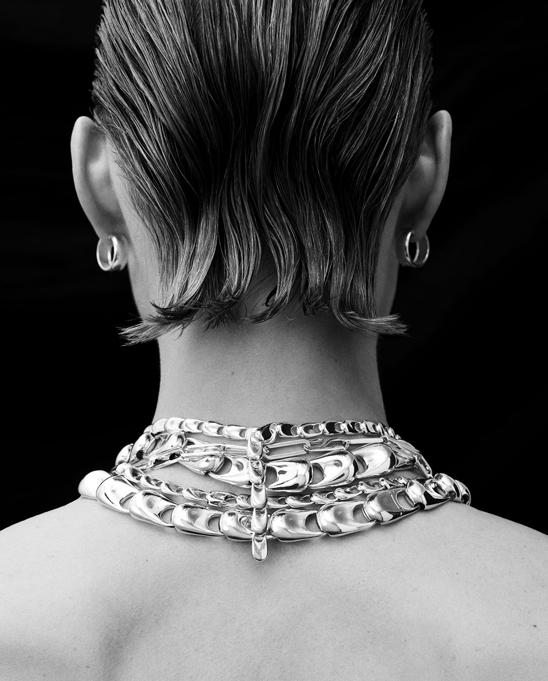 Back of the neck with layers of Electra necklaces
