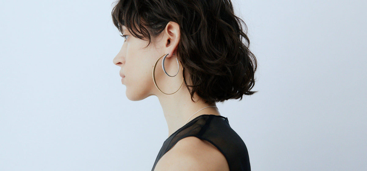 Model wearing KINRADEN GLOW HOOPS