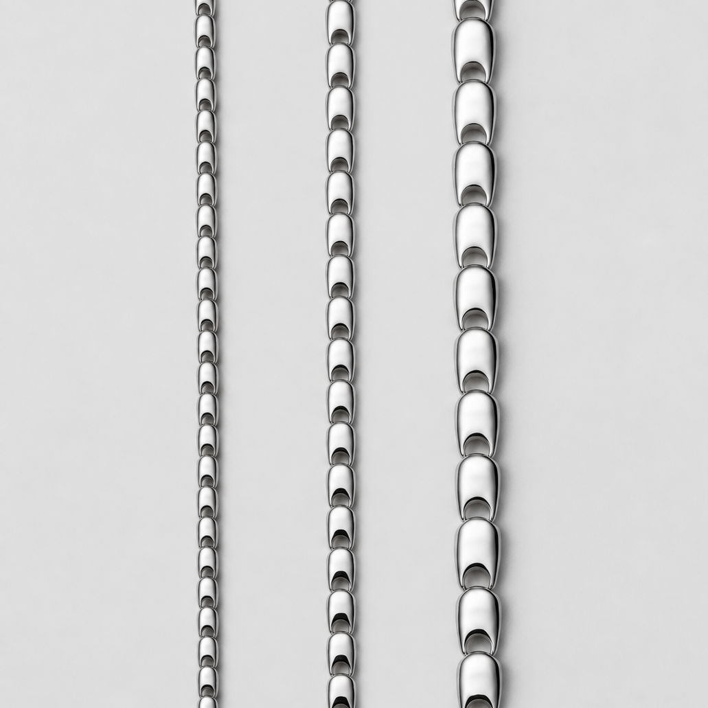 Three vertical close-up views of a polished silver-toned KINRADEN chain necklace on a light gray background, showing different link styles and chain widths.