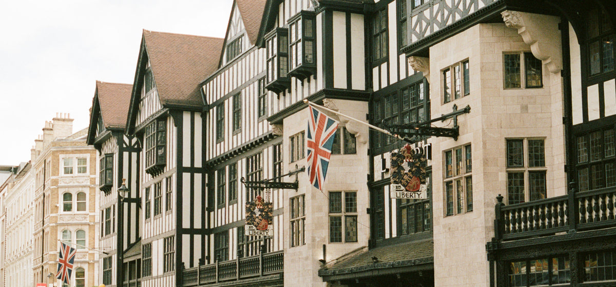 Liberty London’s Tudor-style façade with hanging signs and Union Jack flags.